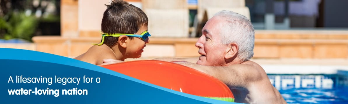 boy with his grandfather in a home swimming pool