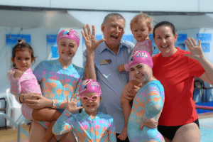 Laurie and Emma Laurence smiling with their hands up showing all 5 fingers