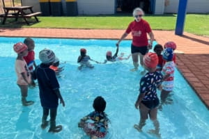 students with their swimming instructor at the Jigalong remote pool