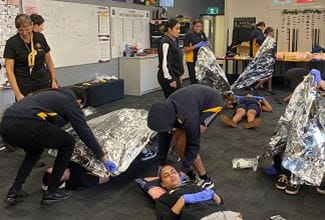 Stars Foundation students practising using emergency blankets