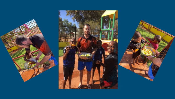 Pool Manager Steve Girschik with children enjoying a bowl of fruit at Warburton