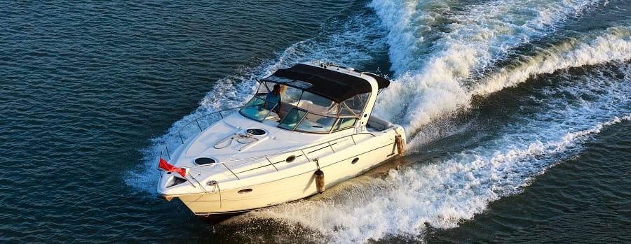 power boat with skipper moving at speed through water