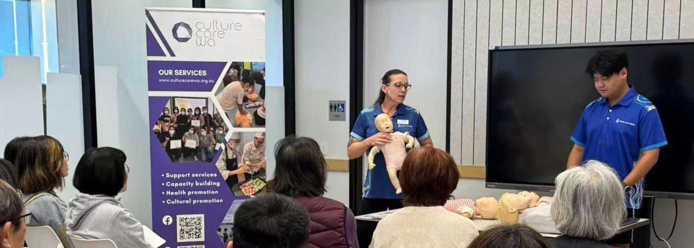 Instructors present while holding CPR dummies