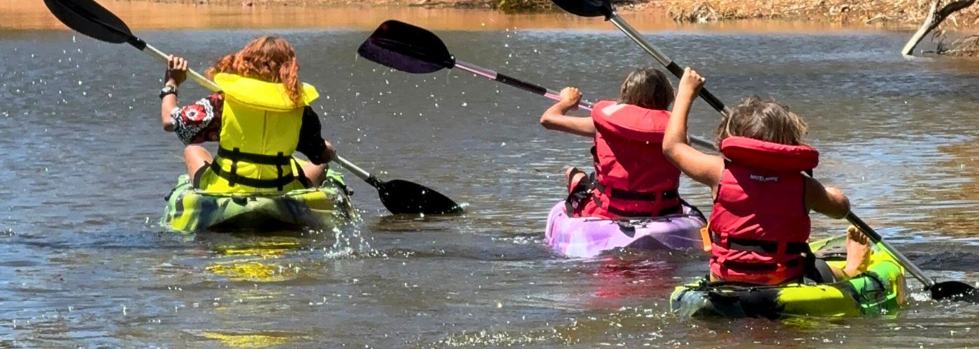 Kids in kayaks paddling