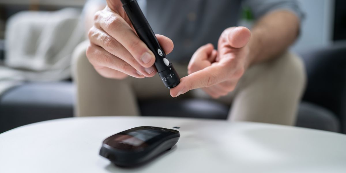 Person pricking finger to check blood sugars
