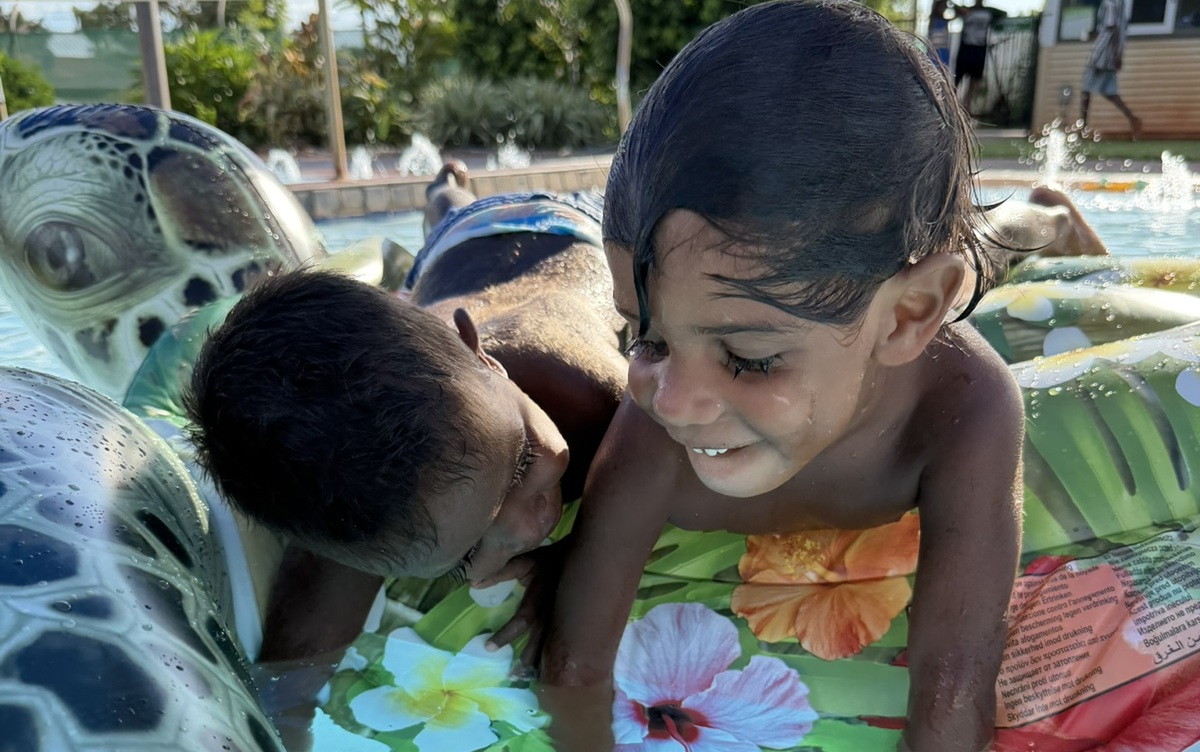 two young children happily playing at the Bidyadanga pool