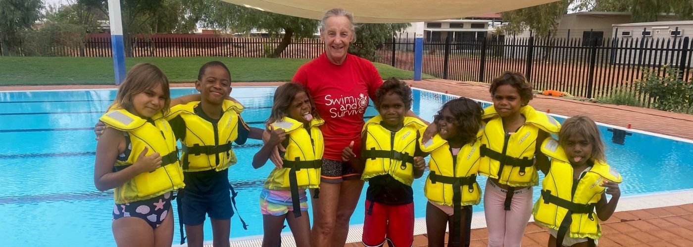 Instructor standing with students wearing lifejackets