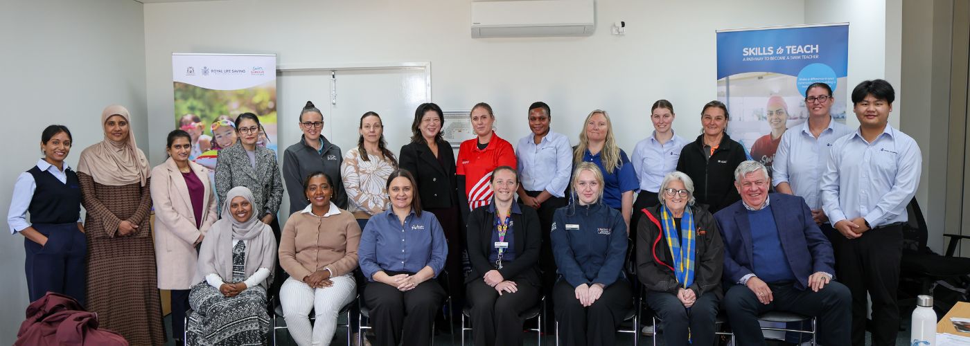 Group photo of committee members and staff seated and standing