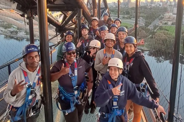 Group posing at Matagarup Bridge zip line