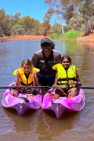 Two kids in kayaks on Sandy Creek