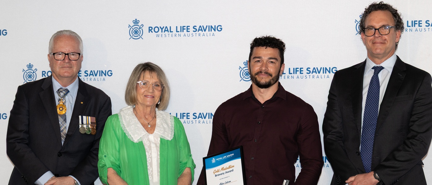 Alex Lebron holding his Gold Medallion Bravery Award