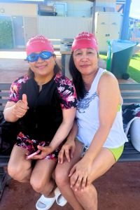 Adult participants sit by the pool