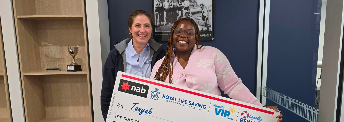 Tanyah with a Royal Life Saving staff member and her prize check