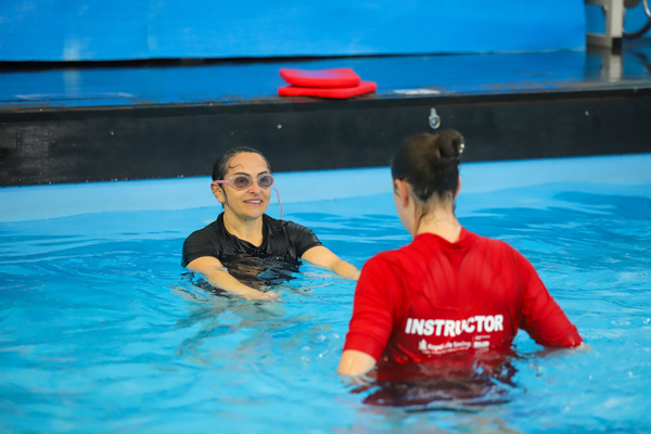 Pool-Robotics-Donation-Article-Additional-3_2025_600X400.png A participant talks to an instructor in the water