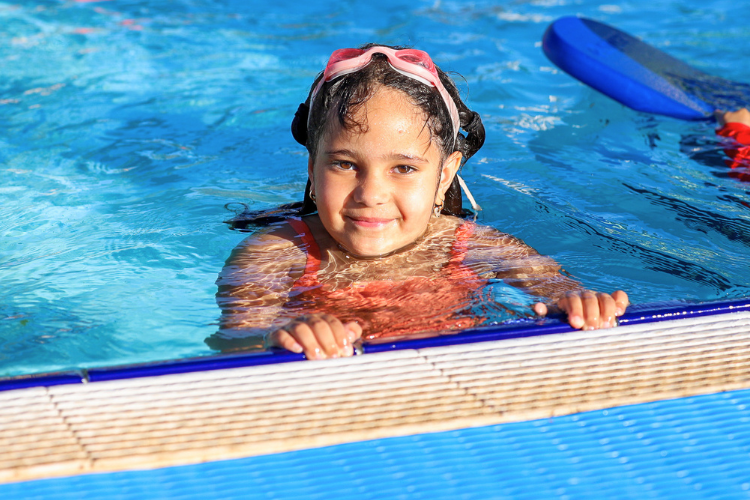 girl smiling from pool