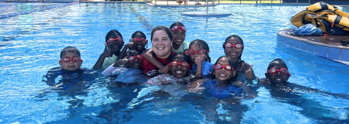 Group of children in the pool smiling