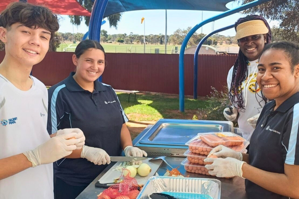 Karlgoorlie-Have-A-Go-Day-Additional-3_2024_600x400.png People stand by the barbecue while preparing food