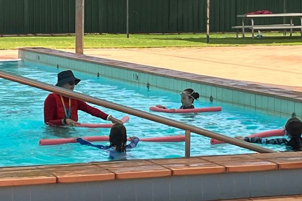Teacher talking to students in the pool