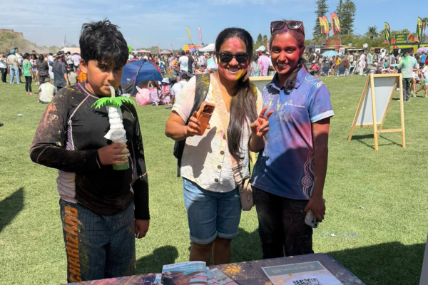 People interacting with Royal Life Saving staff at Holi