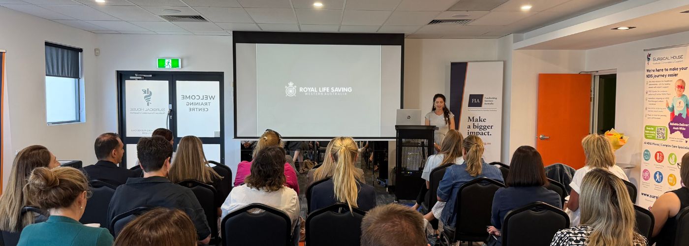Laura presenting in front of room of FIA convention