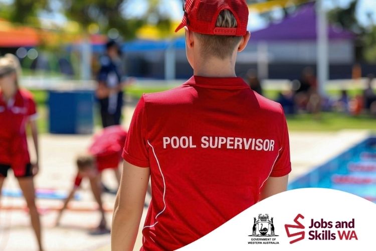 Pool supervisor in a red uniform overseeing activities beside an outdoor swimming pool.