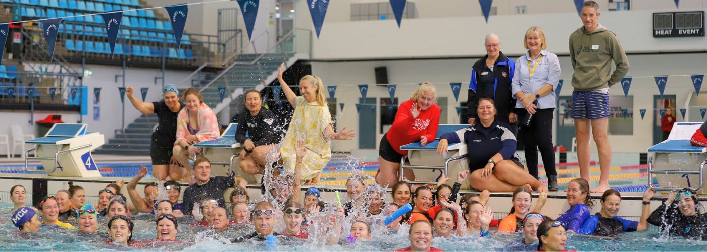 Group photo of swim teachers in the water making a splash