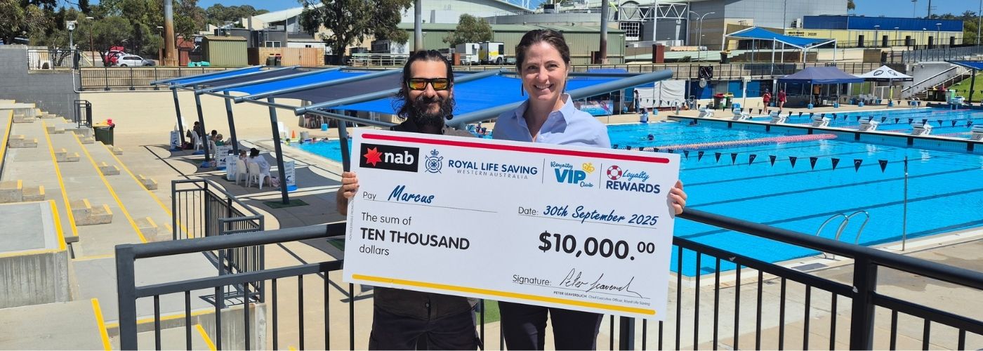 Two people holding giant cheque reading $10,000