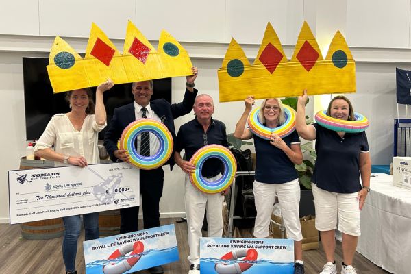 Four people hold up large cardboard crowns