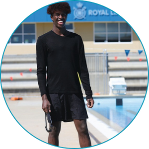 man wearing swim shorts and long sleeve rash shirt