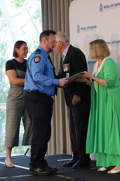 David Vance receiving his bravery certificate from Mrs Darrilyn Dawson