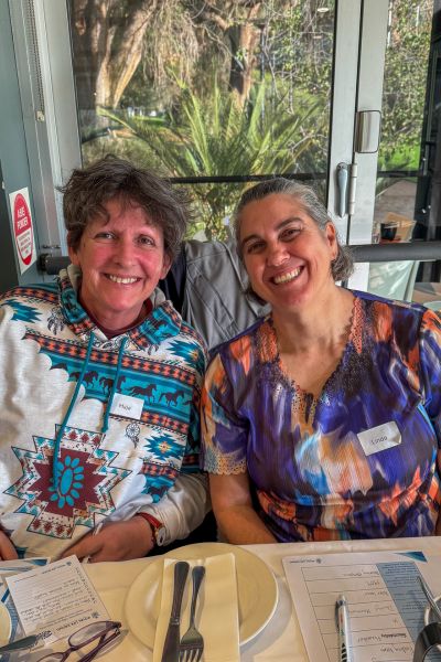 two trainers smiling at EOFY event