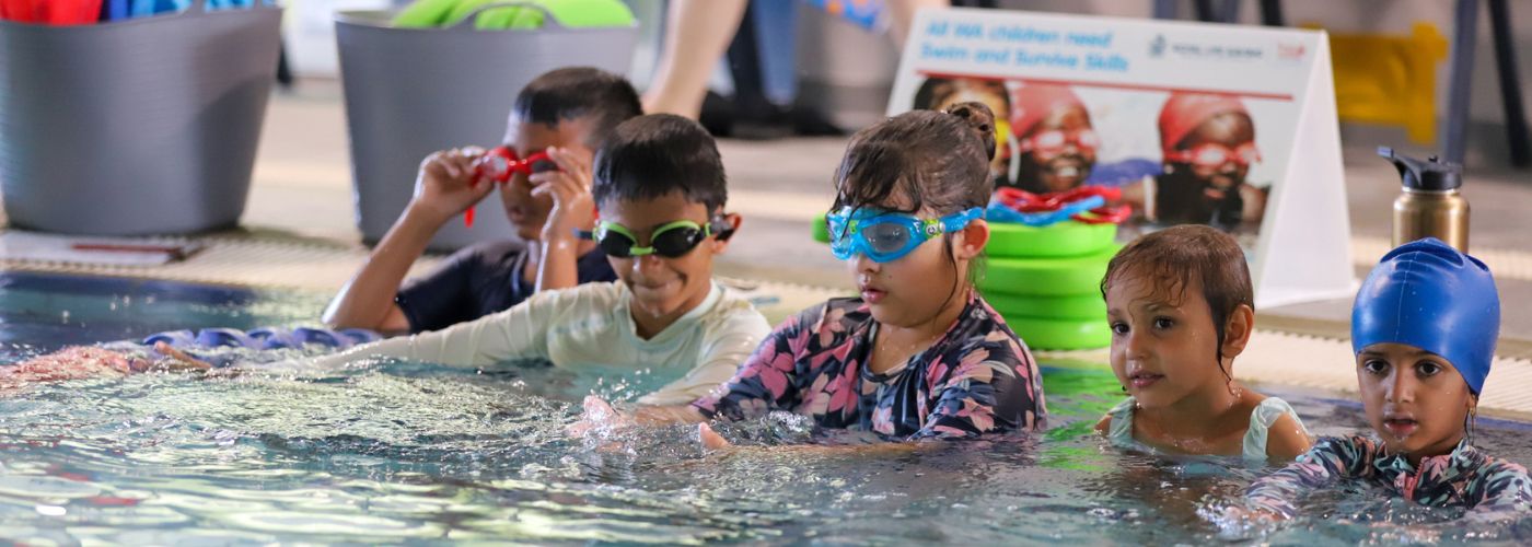 Students lined up against the wall in the pool