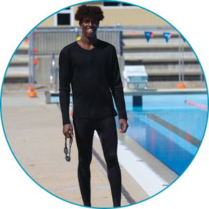 man wearing full length swim leggings and long sleeve rash top