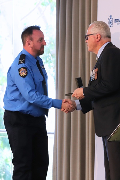 David Vance shaking the hand of WA Governor Chris Dawson APM while receiving his Bravery Award