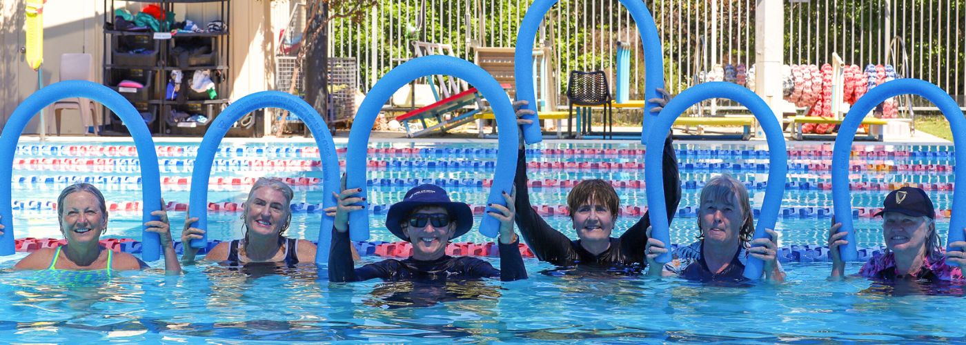 Group photo holding noodles above heads