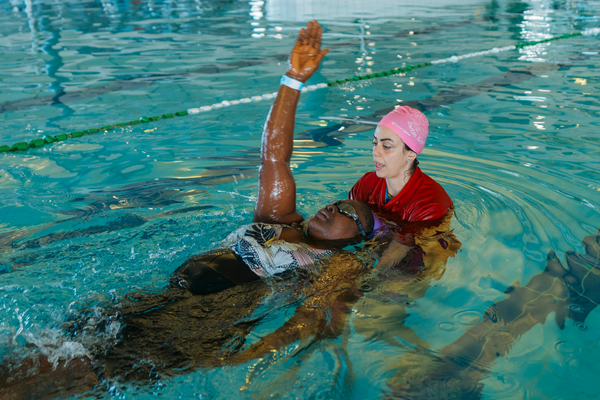 Linda Larbi in the pool with her swimming instructor at Goldfields Oasis
