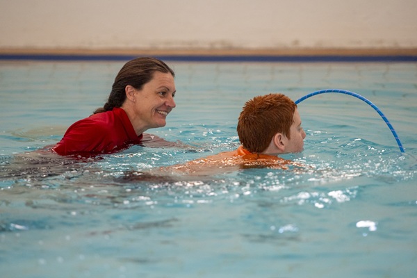 swimming instructor with autistic student