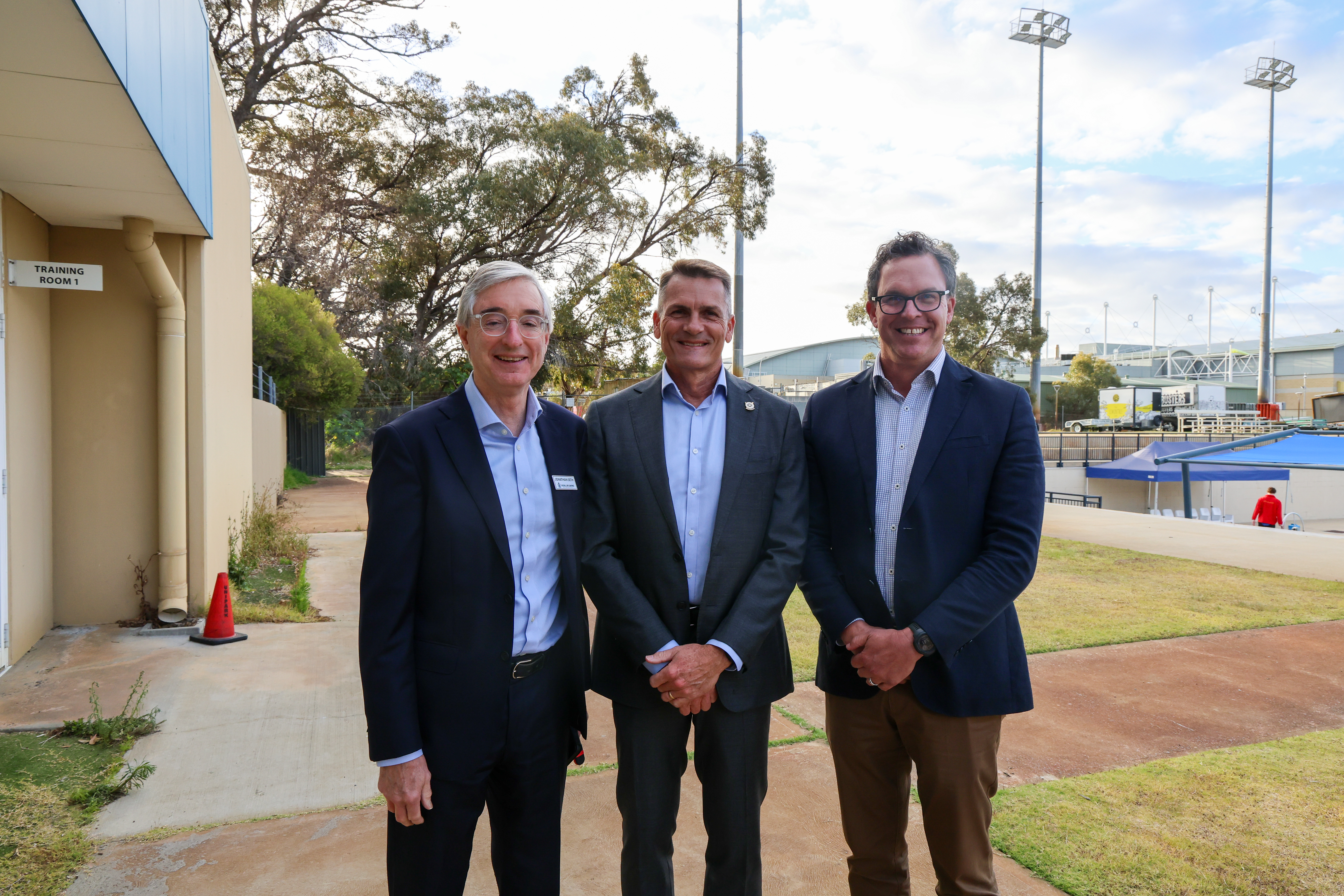 Three men wearing blazers stand together outdoors at Royal Life Saving WA&rsquo;s 2026 AGM.