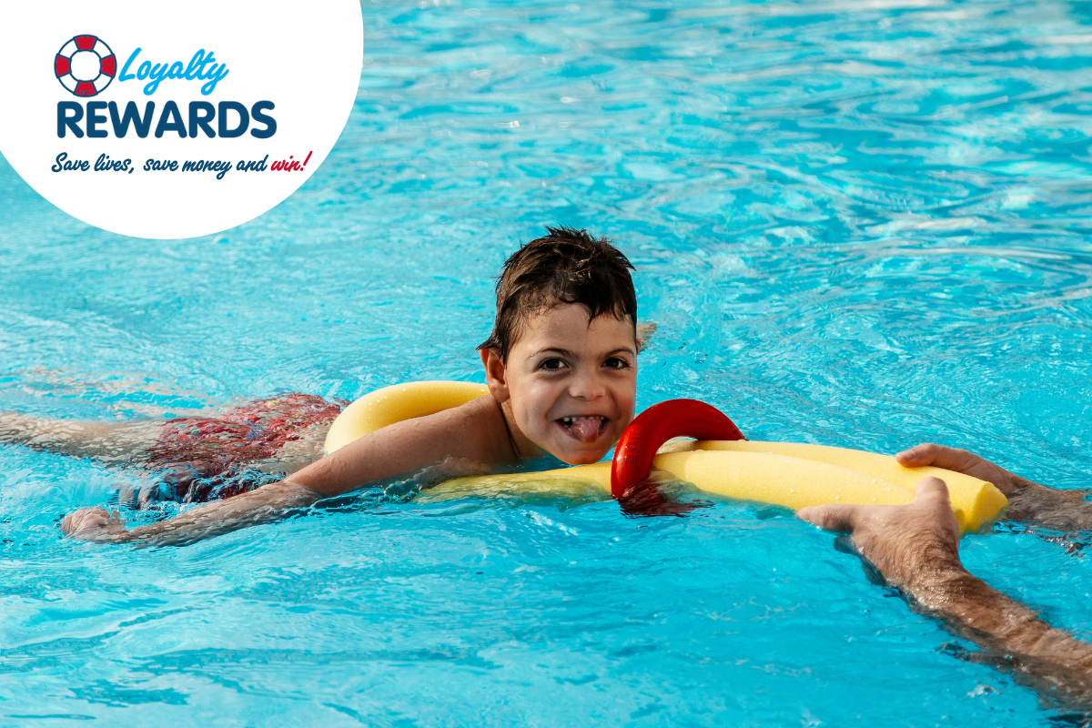 A boy swimming with a lifeguard flotational device