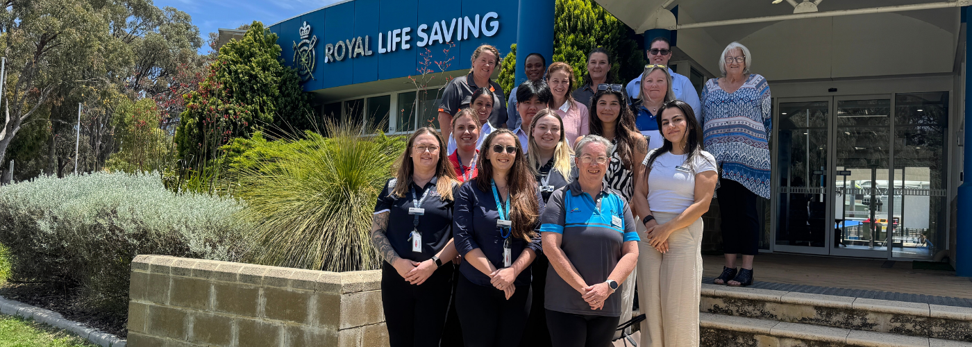 The Royal Life Saving WA Multicultural Steering Committee stand together in front of the Royal Life Saving WA Office