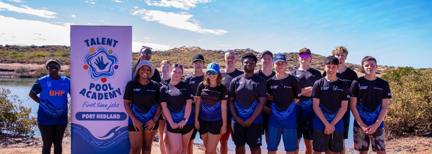 The Port Hedland Talent Pool Academy stand in front of a river