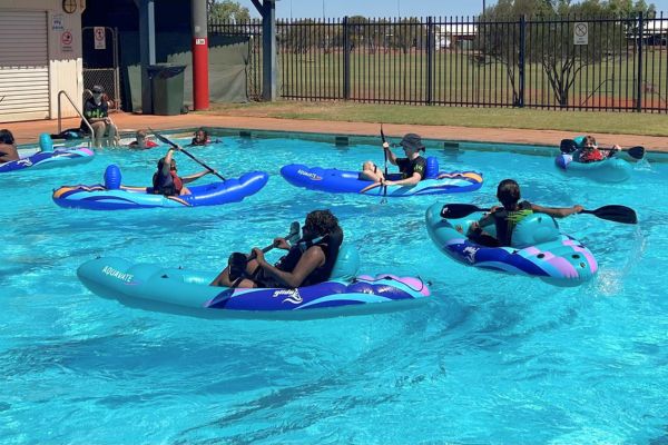 Kids in the pool kayaking