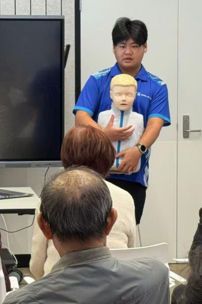 Instructor demonstrates with a CPR dummy