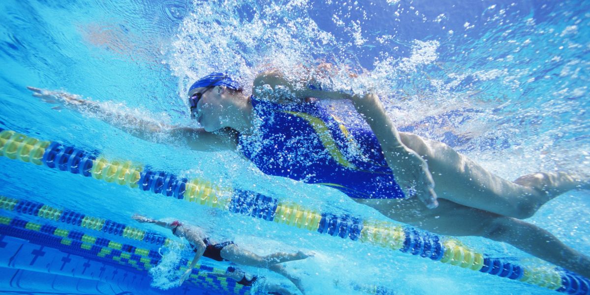 Underwater photo of woman swimming freestyle in pool