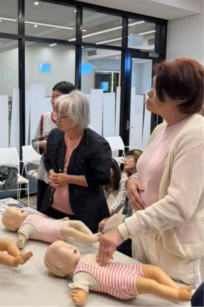 Participants prepare to practice with CPR dummies