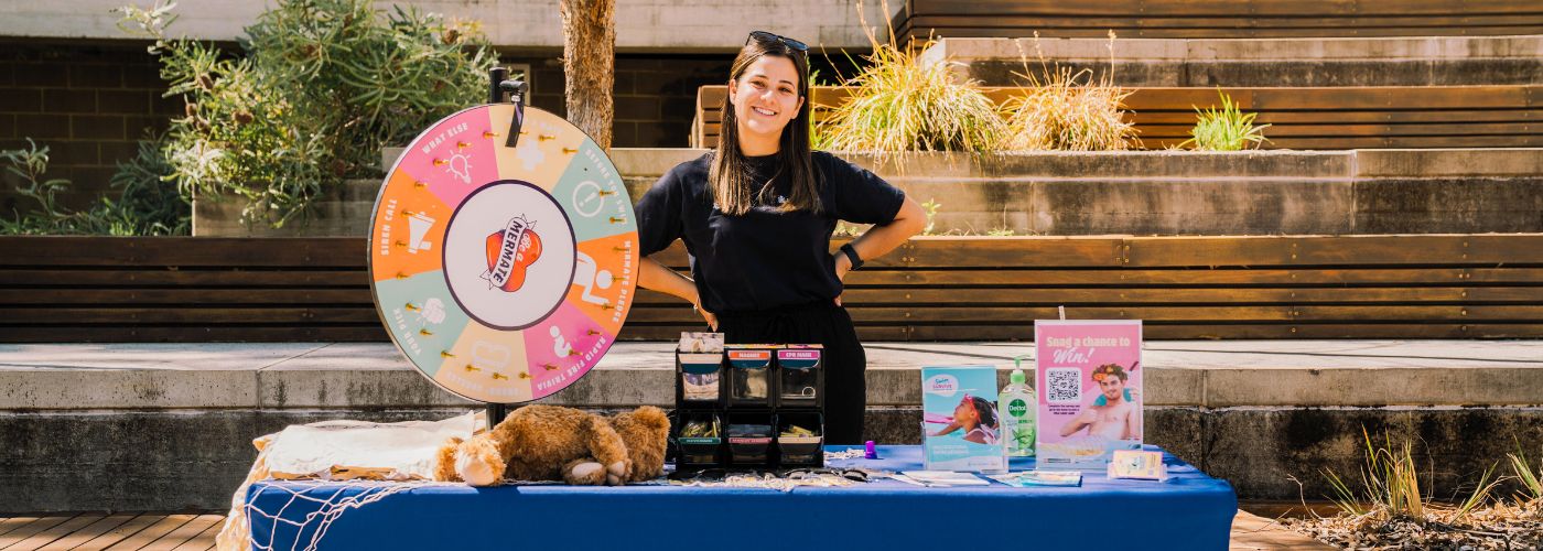 Tneale Maher standing behind Be A Mermate stall table
